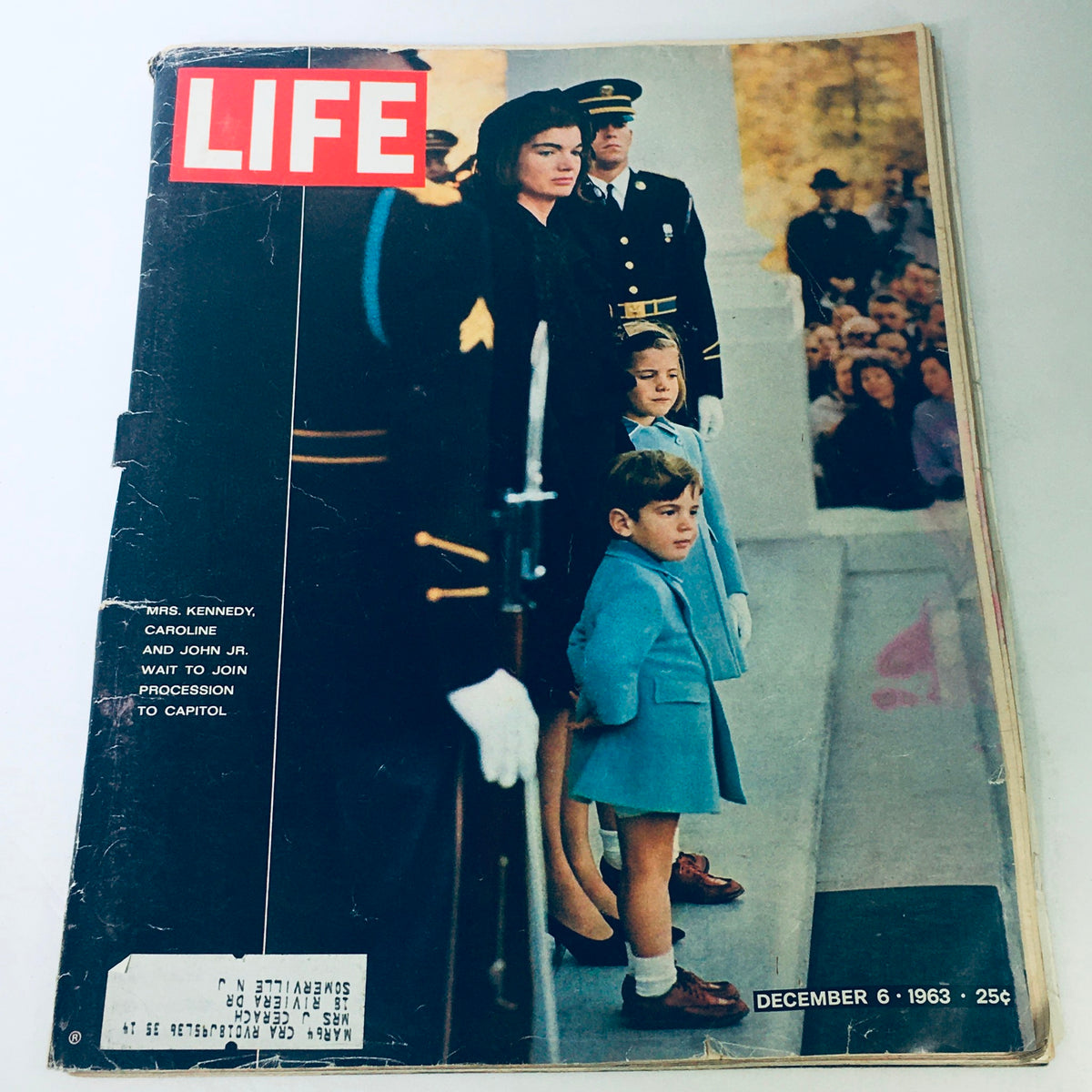 Vintage Life Magazine cover from December 6, 1963 featuring Jackie Kennedy with her children Caroline and John Jr. during a solemn moment. The cover captures the familial bond and historical context of the Kennedy family, a significant piece of Americana.