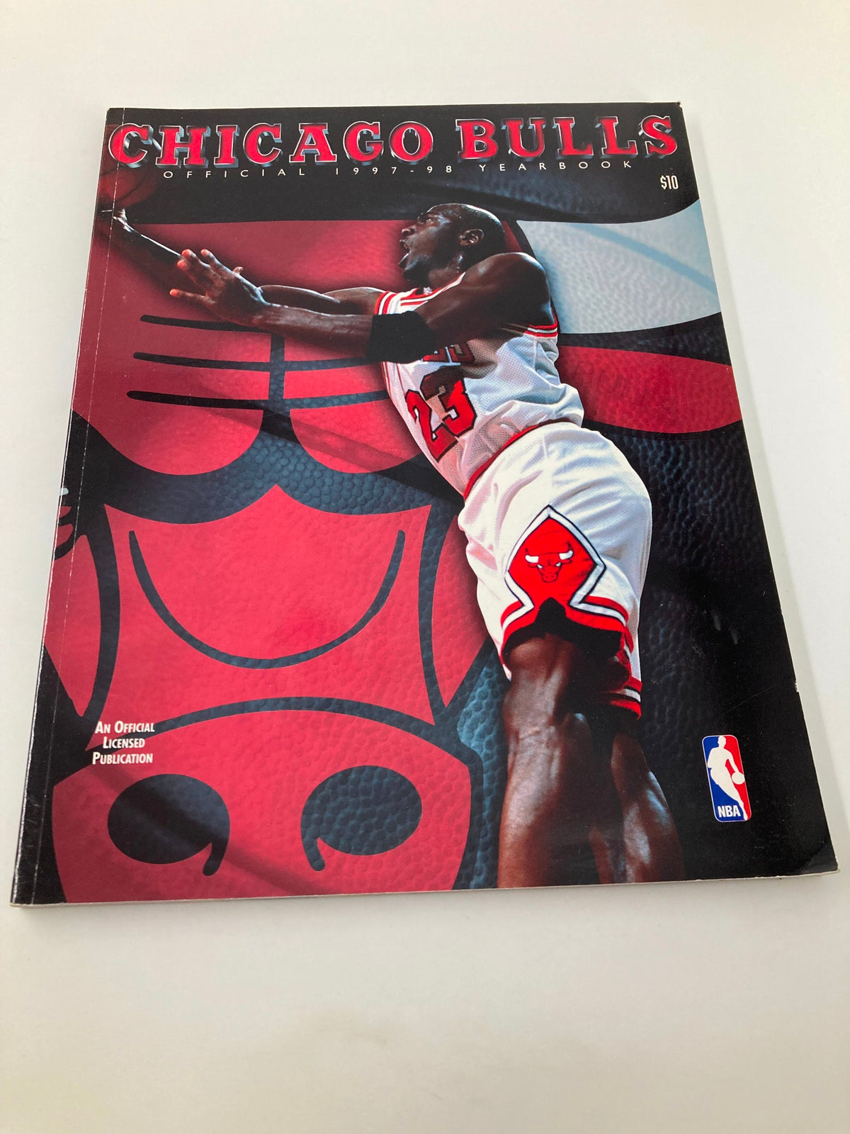 Cover of the NBA Chicago Bulls Official 1997 - 1998 Yearbook, featuring an image of a player in action wearing a Bulls jersey, symbolizing the team’s historic season.