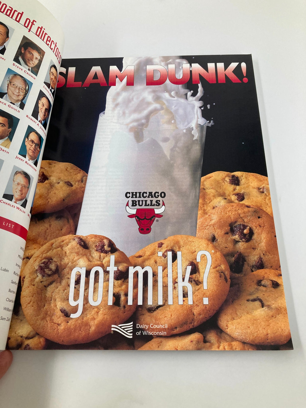 Full-page advertisement in the NBA Chicago Bulls Official 1997 - 1998 Yearbook featuring the slogan 'Slam Dunk!' along with a glass of milk and cookies, promoting a milk campaign.
