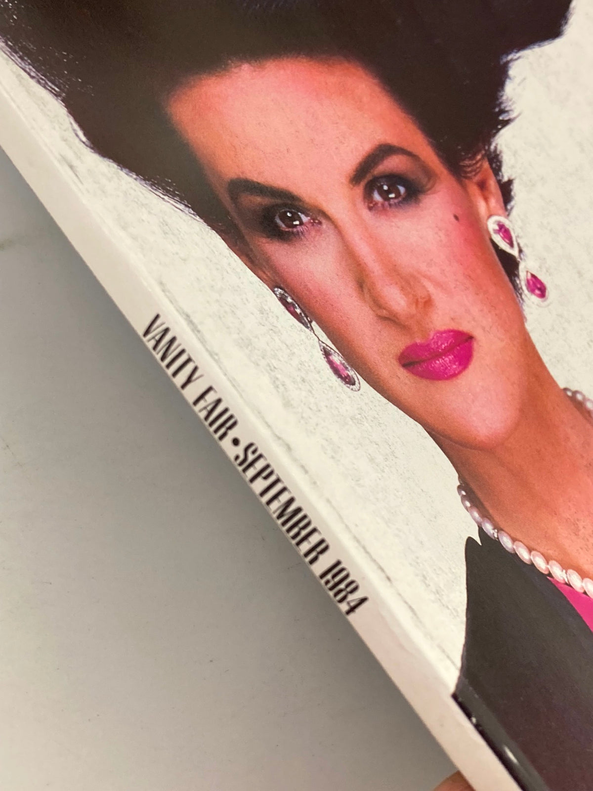 Cover detail of VTG Vanity Fair Magazine September 1984 featuring a stylish model with dramatic makeup and jewelry.