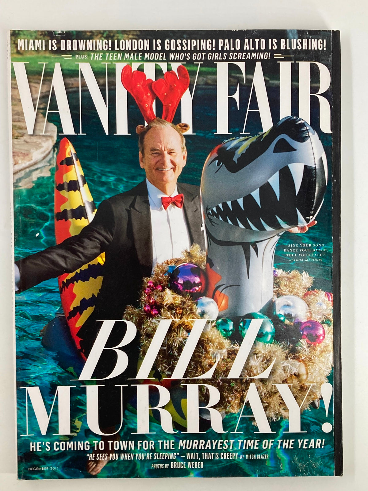 Cover of Vanity Fair Magazine December 2015 featuring Bill Murray, dressed in a tuxedo, surrounded by a festive backdrop with holiday decorations and a playful dinosaur float. This edition is titled 'Time of the Year'.