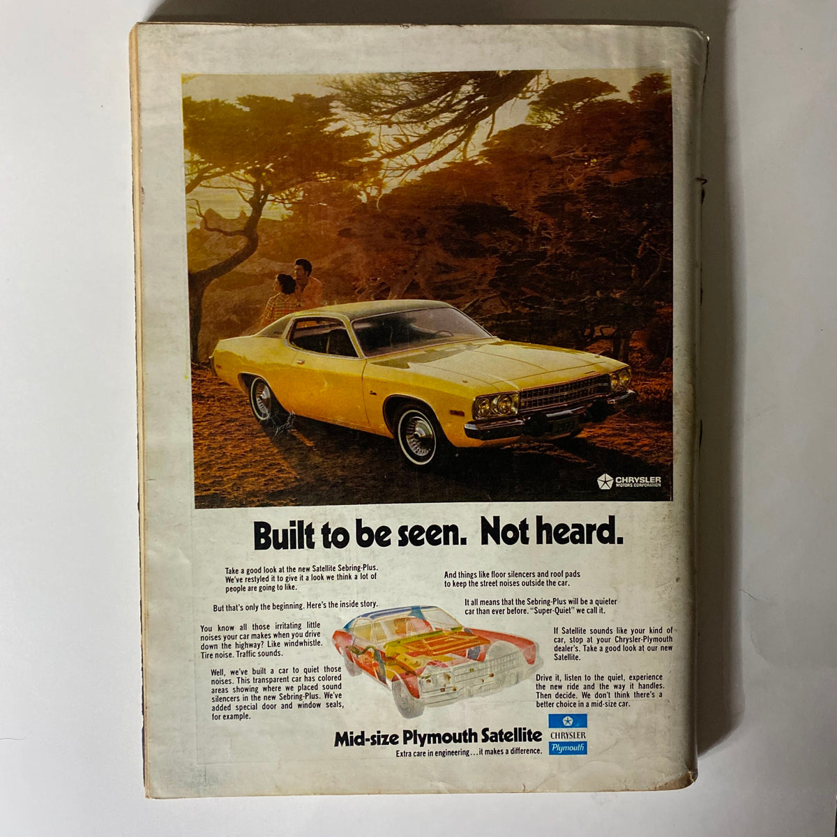 Back cover of VTG Playboy Magazine December 1972 featuring a classic advertisement for the mid-size Plymouth Satellite car, emphasizing design and performance.