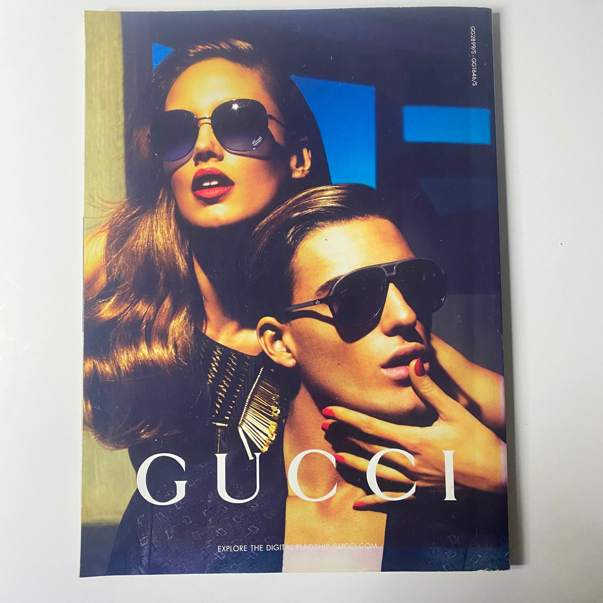 Gucci advertisement featured in Harper's Bazaar UK Magazine May 2011, showcasing a glamorous couple in sunglasses exuding high-fashion appeal and sophistication.