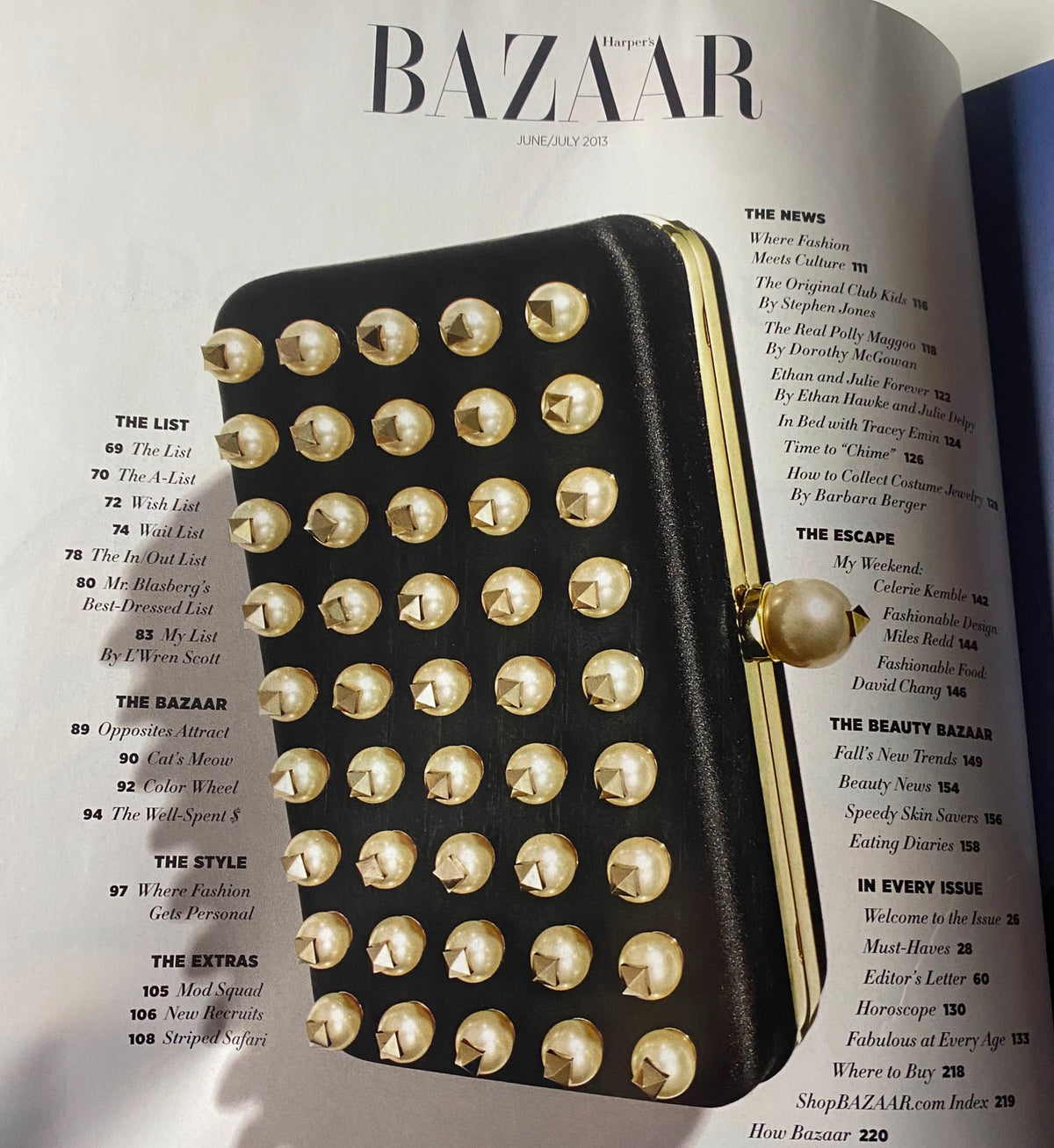 Another interior page of Harper's Bazaar Magazine June - July 2013 displaying a stylish black clutch, highlighting fashion and accessory trends.