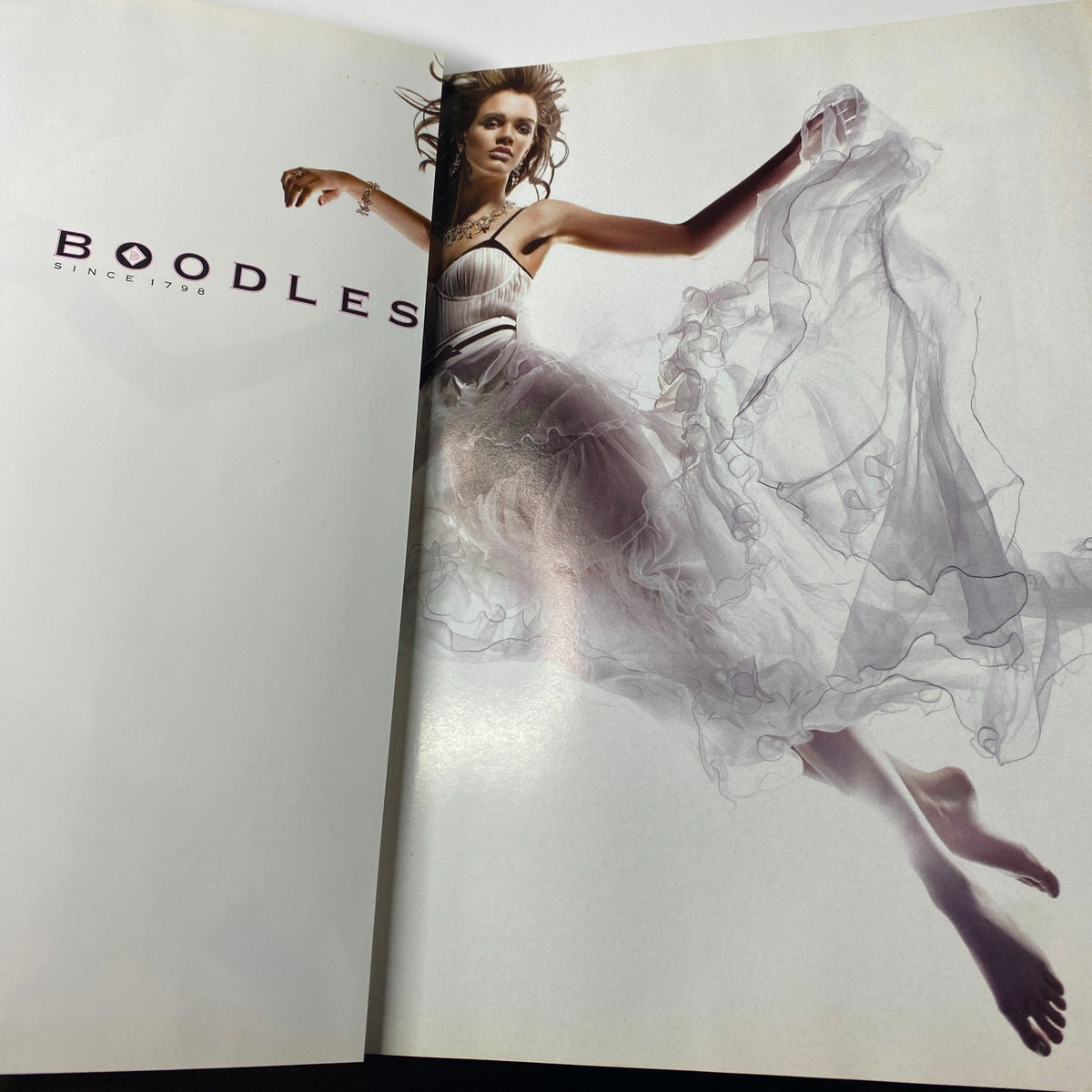 Elegant advertising spread from Harper's Bazaar British Magazine July 2007 featuring a model in a flowing gown, advertising Boodles jewelry, highlighting luxury fashion.