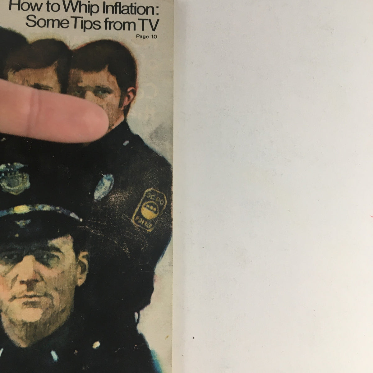 Close-up of the TV Guide Magazine February 15, 1975 cover highlighting the article 'How to Whip Inflation: Some Tips from TV' with part of the image of police officers.