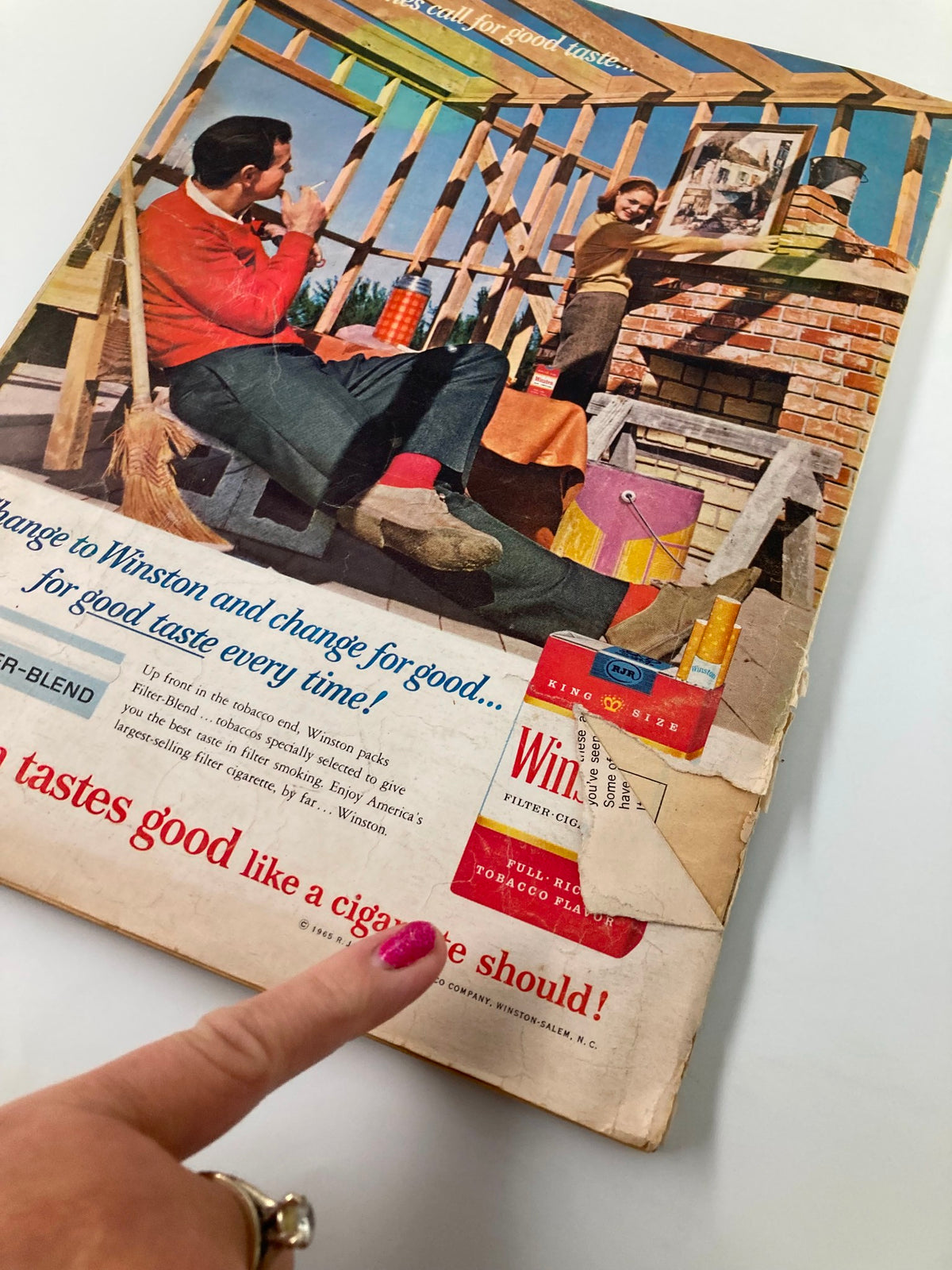 Cover image of VTG Redbook Magazine April 1965 featuring a colorful scene with a man relaxing and a woman decorating a home, promoting Winston cigarettes with vintage art.
