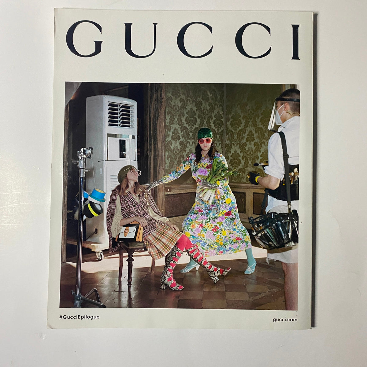Cover of Gucci magazine showcasing a vibrant fashion ensemble in an artistic setting, reflecting bold creativity and innovative styles.