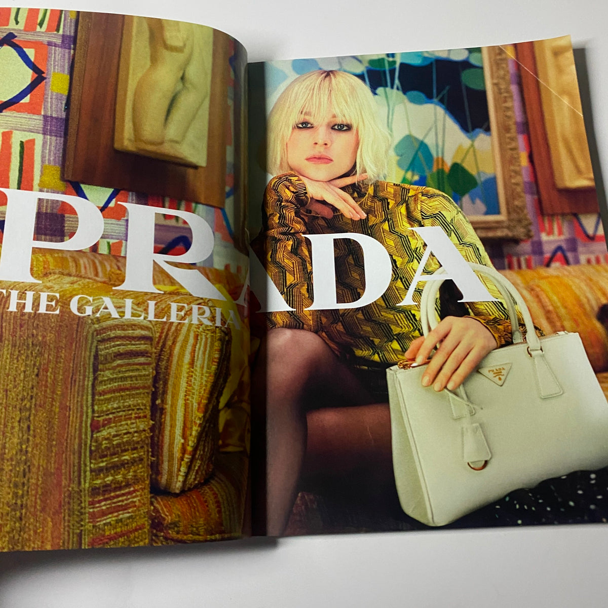 Harper's Bazaar UK Magazine August 2021 featuring a striking PRADA advertisement with a model in a patterned outfit, seated in a colorful interior, highlighting contemporary fashion.