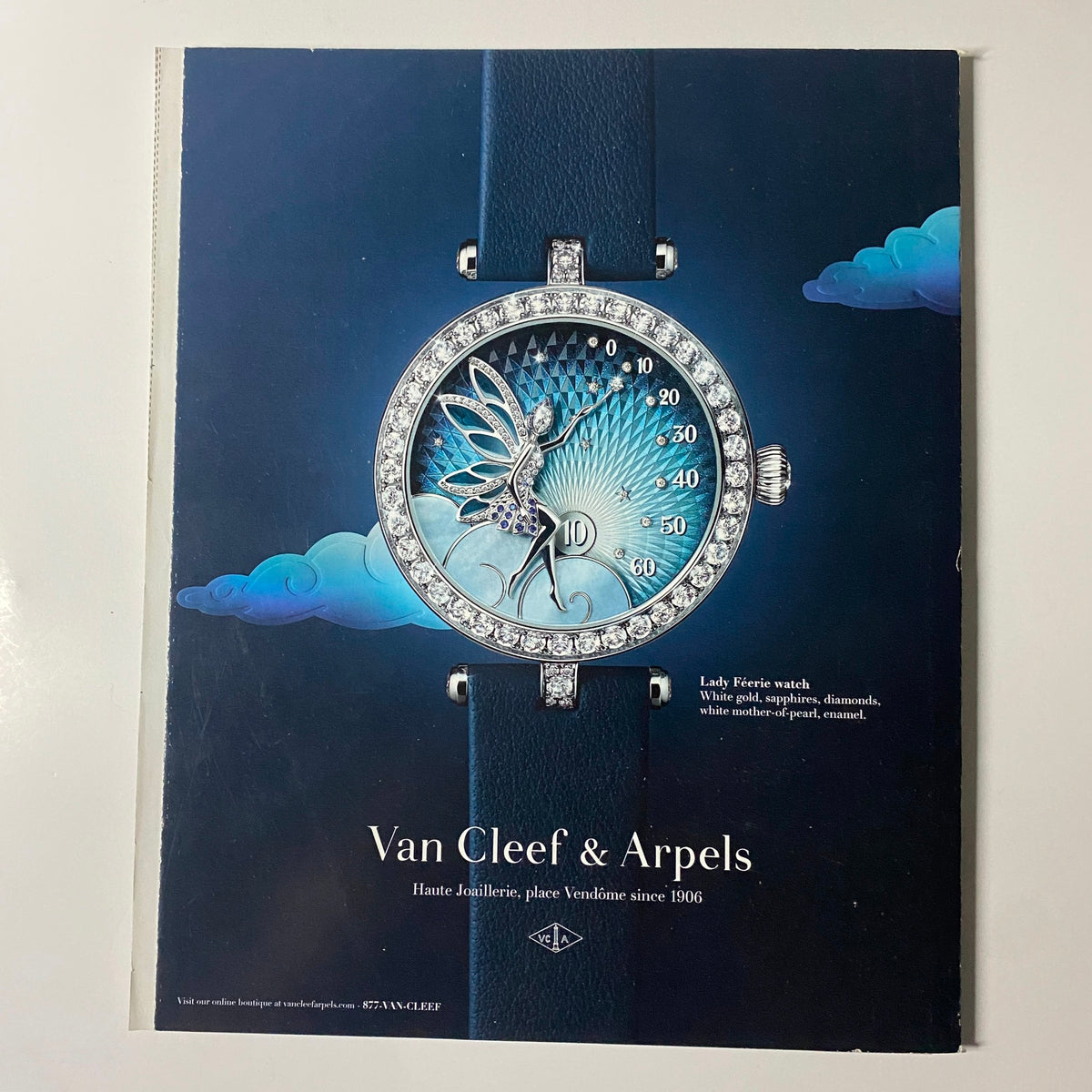 Van Cleef & Arpels advertisement showcasing a Lady Birds watch with intricate design against a serene background. Featured in Harper's Bazaar Magazine April 2022 with Renée Zellweger on the cover.