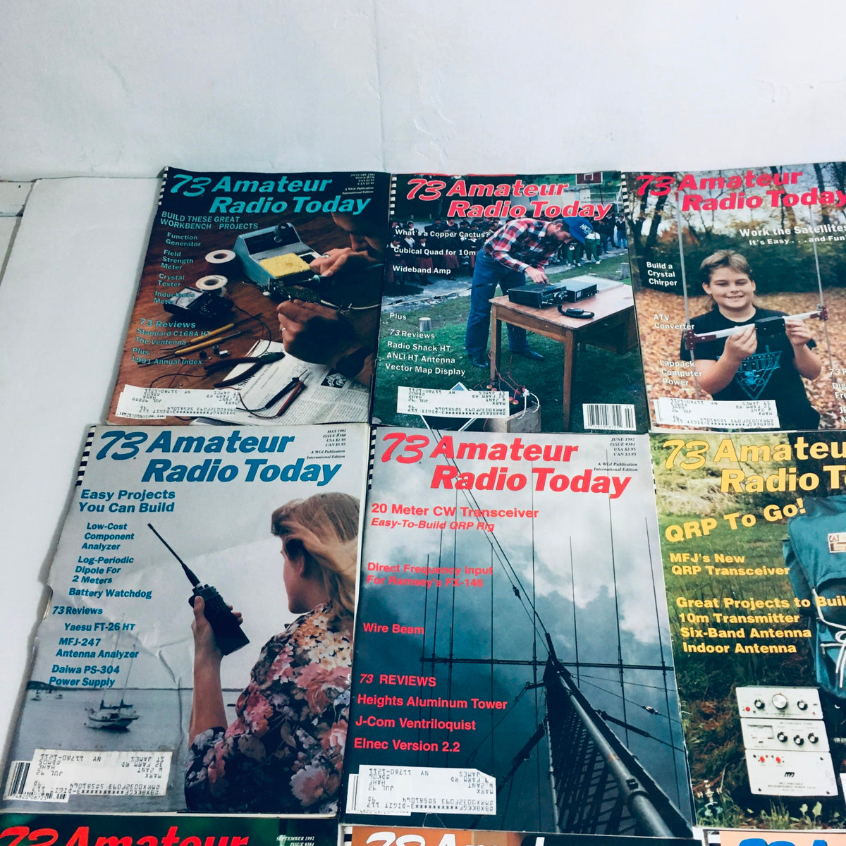 Lot of 12 Complete January to December 1992 73 Amateur Radio Volume 1 to 12 magazines displayed showing different issues with titles focusing on amateur radio building projects and equipment.