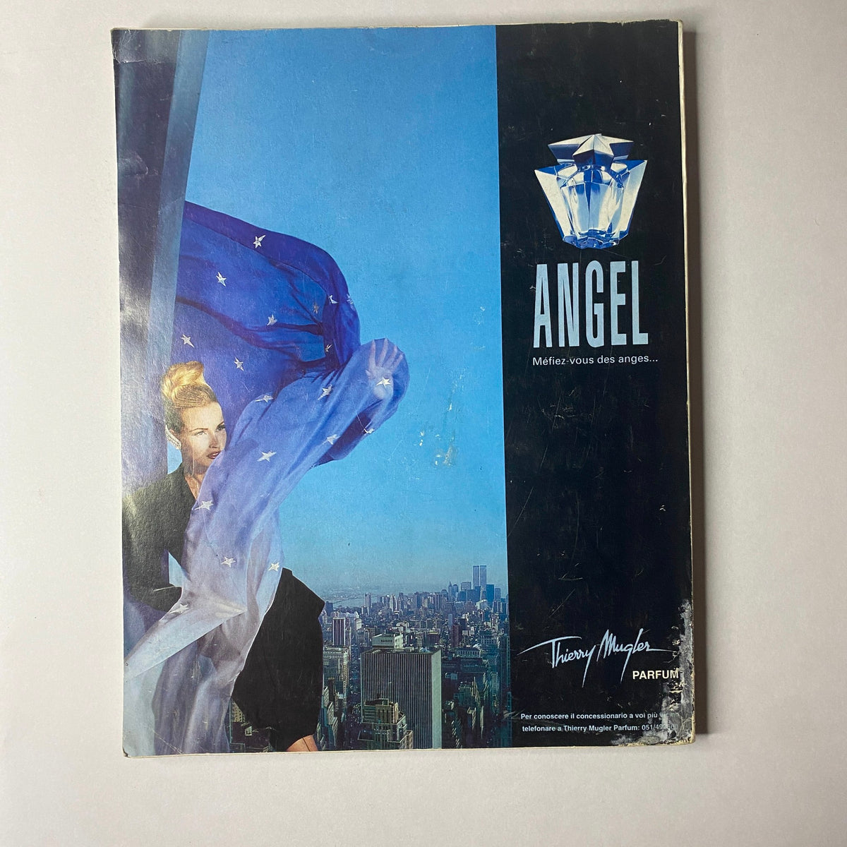 Thierry Mugler advertisement for the fragrance 'Angel' displaying a model against a cityscape background, part of the Marie Claire Italia December 1993 issue with Tatjana Patitz cover.