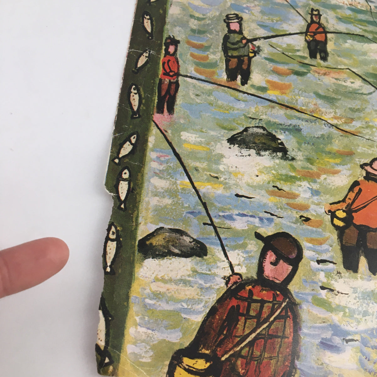 Close-up view of The New Yorker April 23 1955 cover by Abe Birnbaum, highlighting details of fishermen and decorative fish border.