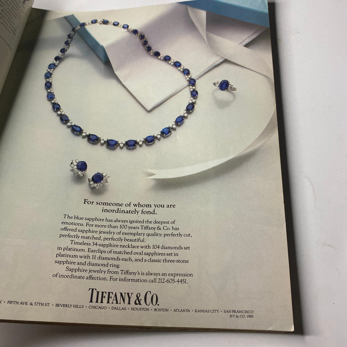 Tiffany & Co. advertisement featuring a stunning sapphire necklace and earrings, highlighting the elegance of blue sapphire jewelry, from the Town & Country Magazine September 1985 issue with Nina Griscom cover.