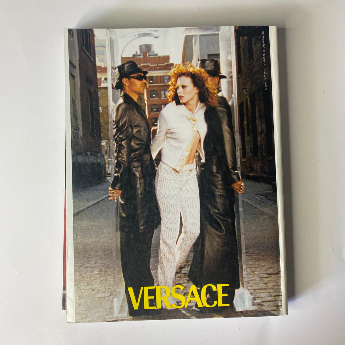 A visually captivating advertisement from Vogue Magazine November 1999, featuring Versace, showcasing cutting-edge fashion, alongside the famous Kate Moss and Gisele Bündchen cover.