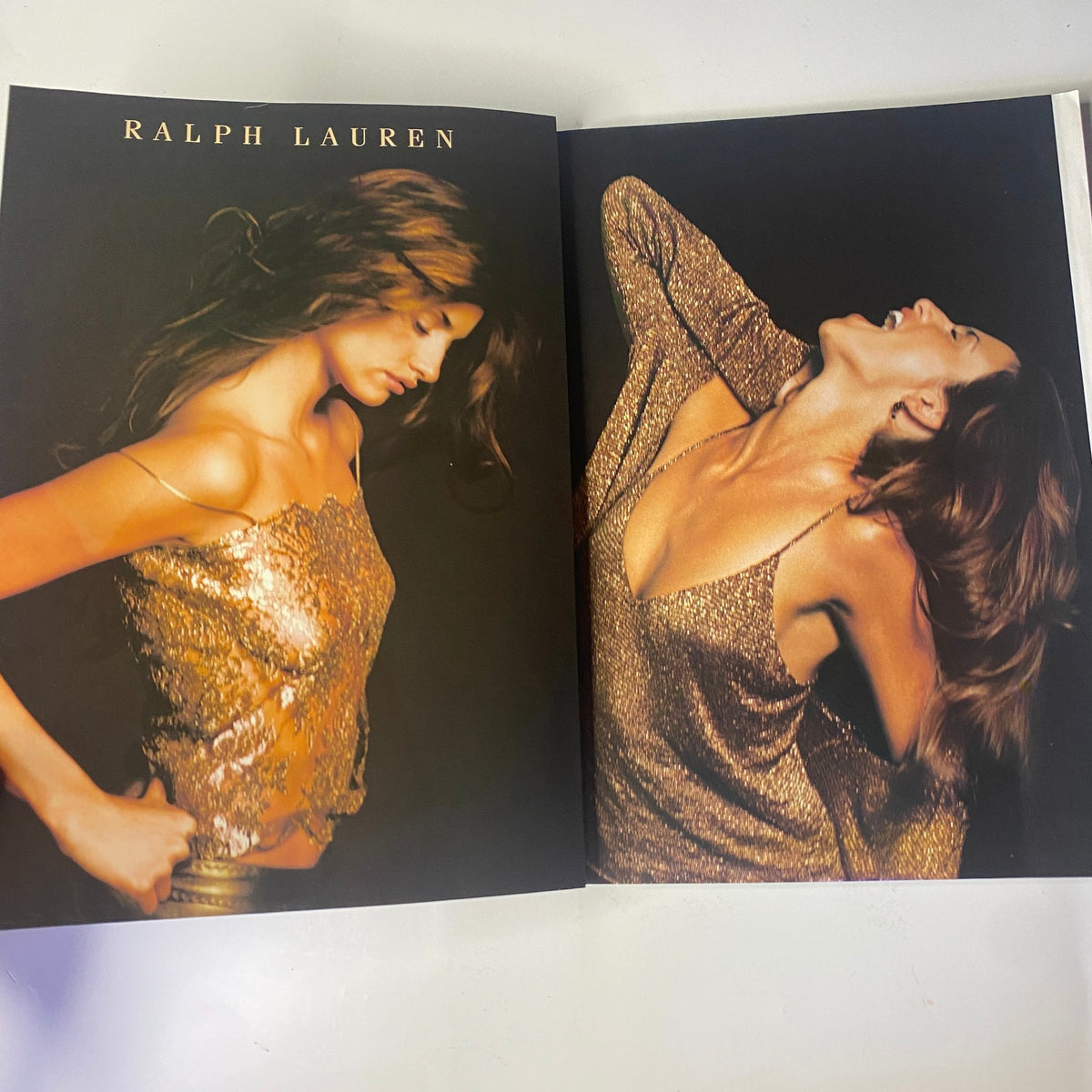 A fashion feature spread in August 2000 Vogue Magazine by Ralph Lauren, presenting glamorous models in luxurious outfits, emphasis on the glittering styles of early 2000s fashion in very good condition.