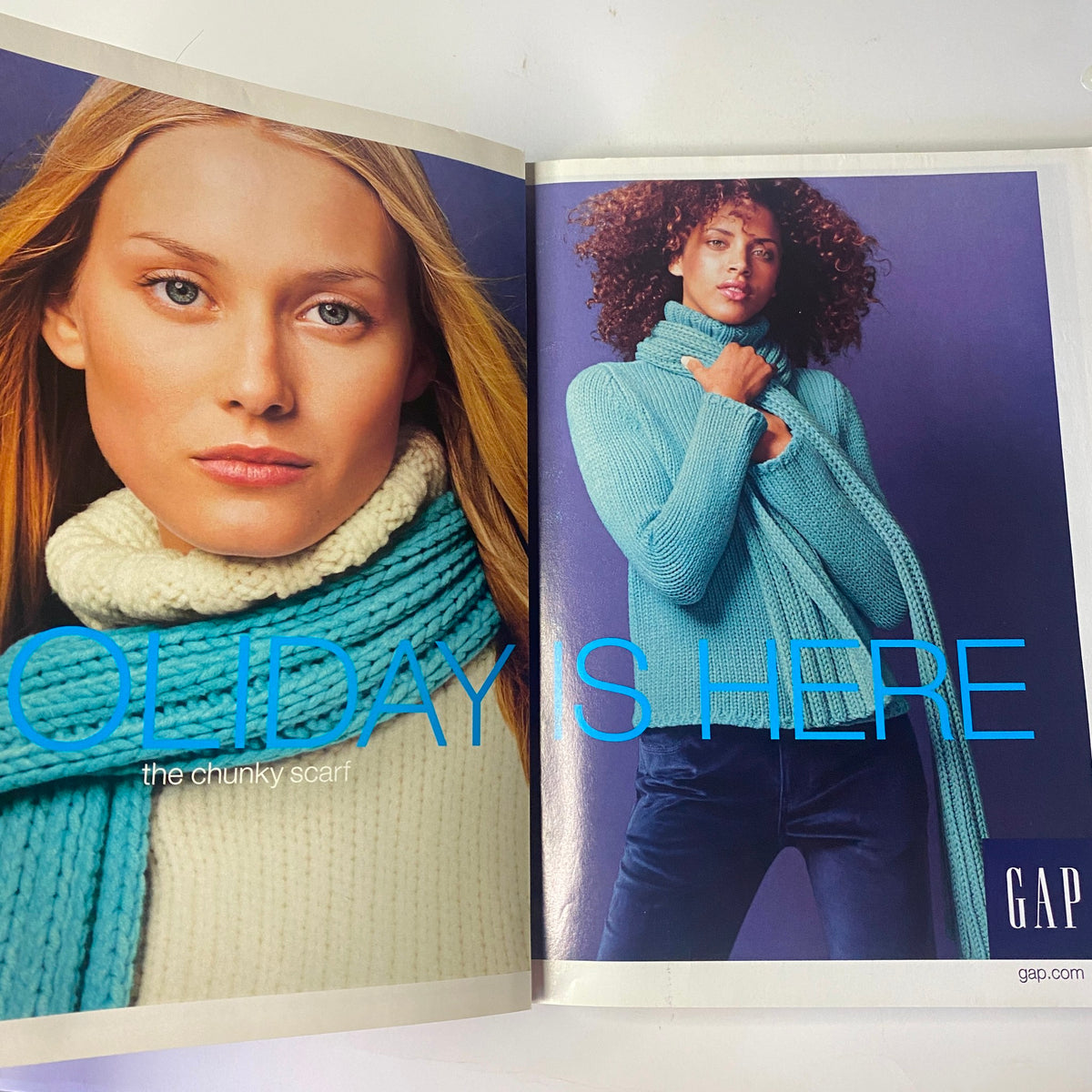 GAP advertisement featuring a model showcasing a chunky scarf, styled in a cozy winter look, with text saying 'HOLIDAY'S HERE' from Vogue Magazine December 2000 Nicole Kidman Cover.