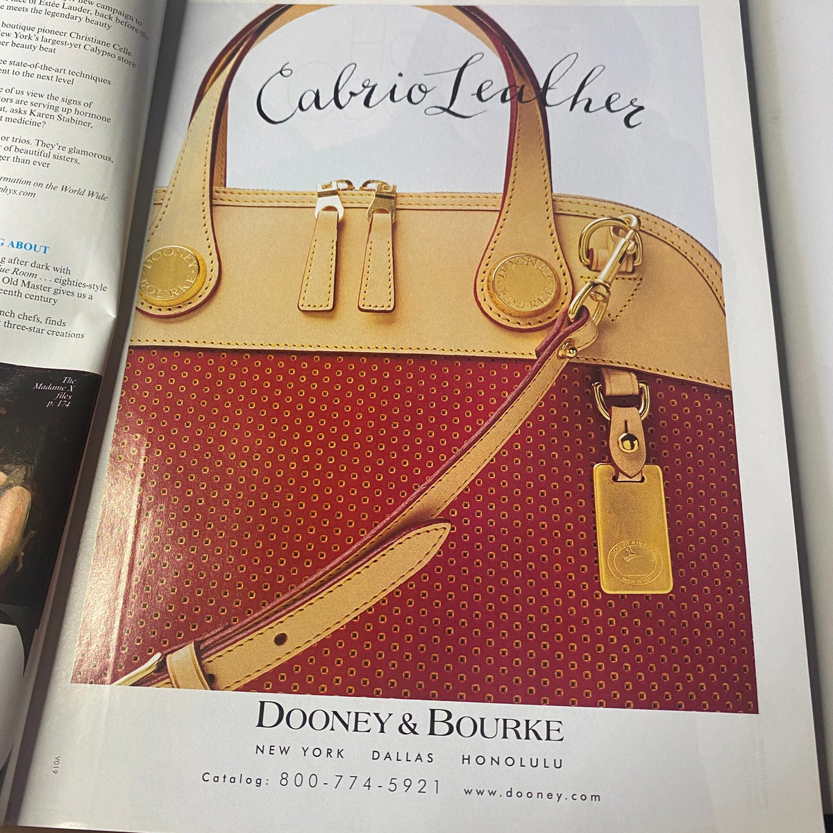 Advertisement for Dooney & Bourke in Vogue Magazine January 1999 featuring a stylish leather handbag in eye-catching colors.