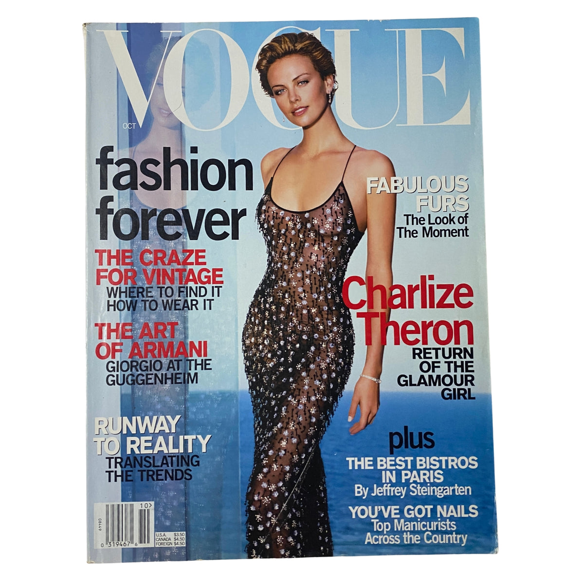 Vogue Magazine October 2000 cover featuring Charlize Theron in a dazzling sequined gown, highlighting fashion with the theme 'Fashion Forever' and showcasing notable articles. A collectible issue in very good condition.