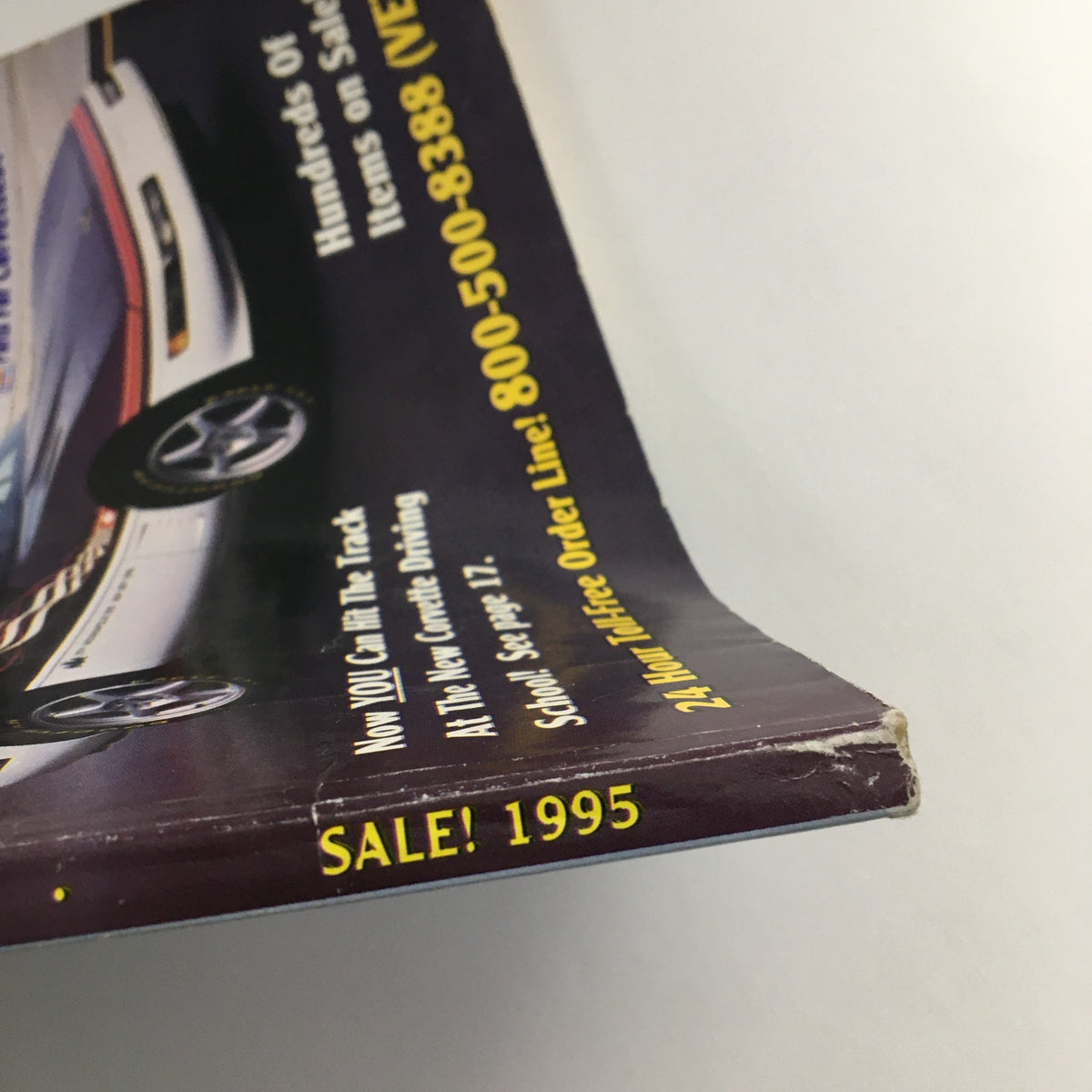 Close-up view of the spine of the Mid America Designers Inc. Catalog 1995 Parts & Accessories for Corvettes highlighting the SALE! 1995 promotion.