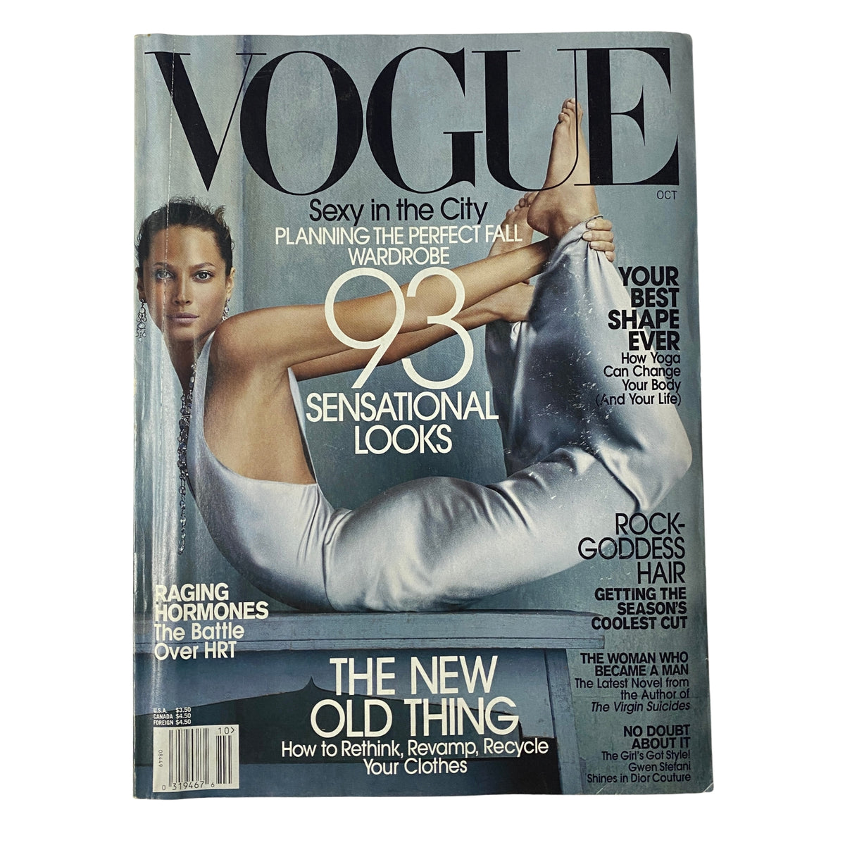 Vogue Magazine October 2002 featuring supermodel Christy Turlington on the cover, showcasing a fashion layout with themes of sensuality and wellness. The magazine emphasizes '93 Sensational Looks' and explores key fashion topics from the early 2000s.