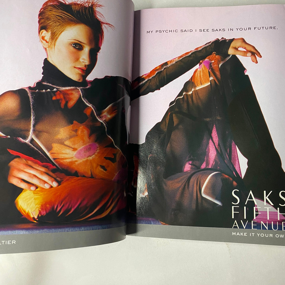 Vogue Magazine September 2002 featuring a vibrant Saks Fifth Avenue ad with a model in artistic attire, embodying contemporary fashion trends.