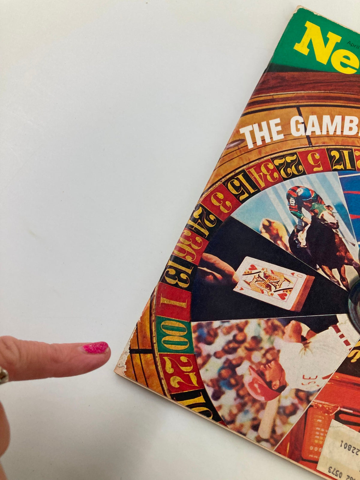 Close-up of the front cover of VTG Newsweek Magazine April 10 1972, highlighting details of 'The Gambling Explosion' with a finger pointing at the roulette section.