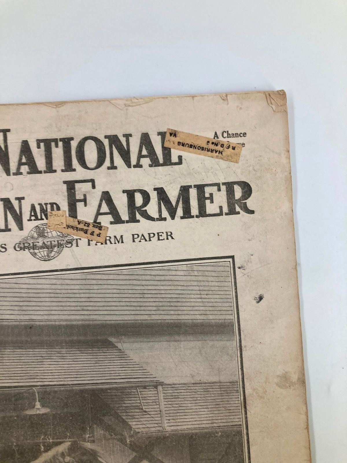 Detail of the VTG The National Stockman and Farmer magazine showing vintage advertisements and the title.