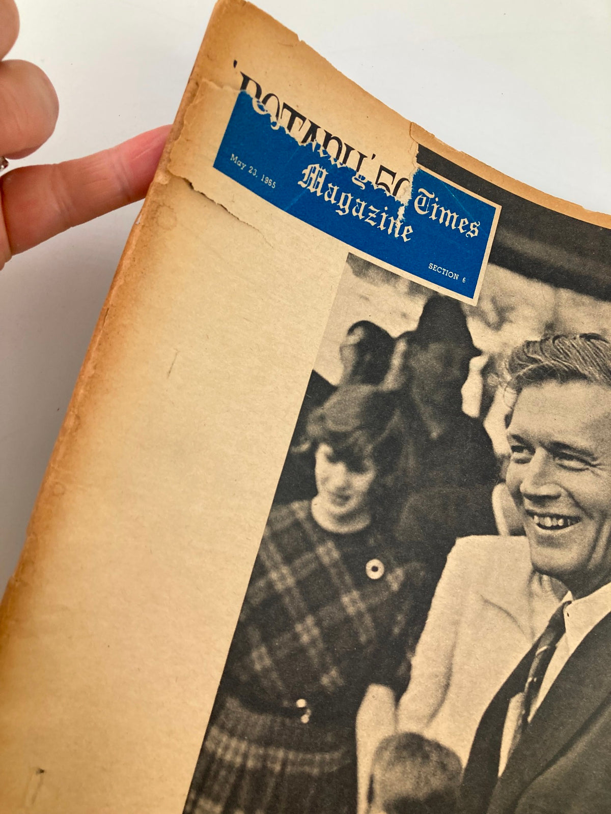 Close-up of the cover page of VTG The New York Times Magazine from May 23, 1965, showcasing John Lindsay. The image highlights the magazine's wear and tear, including a torn corner and vintage design, making it a unique collector's item.