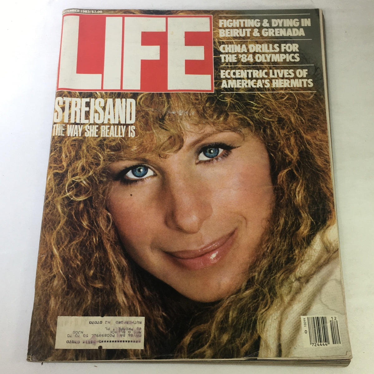 Vintage Life Magazine December 1983 featuring Barbra Streisand on the cover, highlighting her captivating portrait and curly hair with bright blue eyes, embodying 80s pop culture.