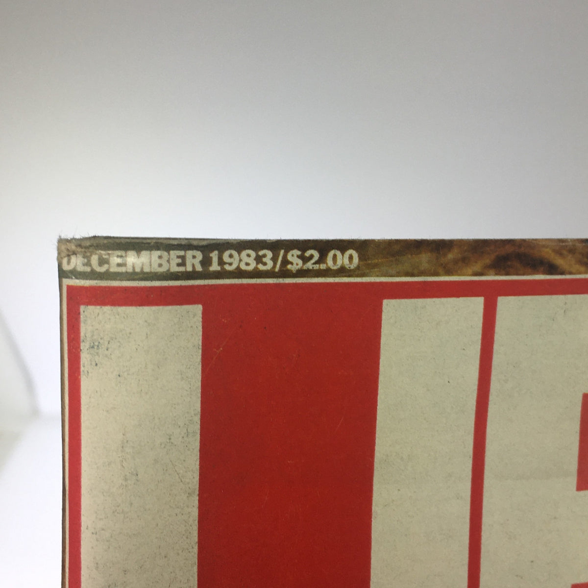 Close-up of the top edge of the Vintage Life Magazine December 1983, displaying the publication date and price, emphasizing its collectible nature.