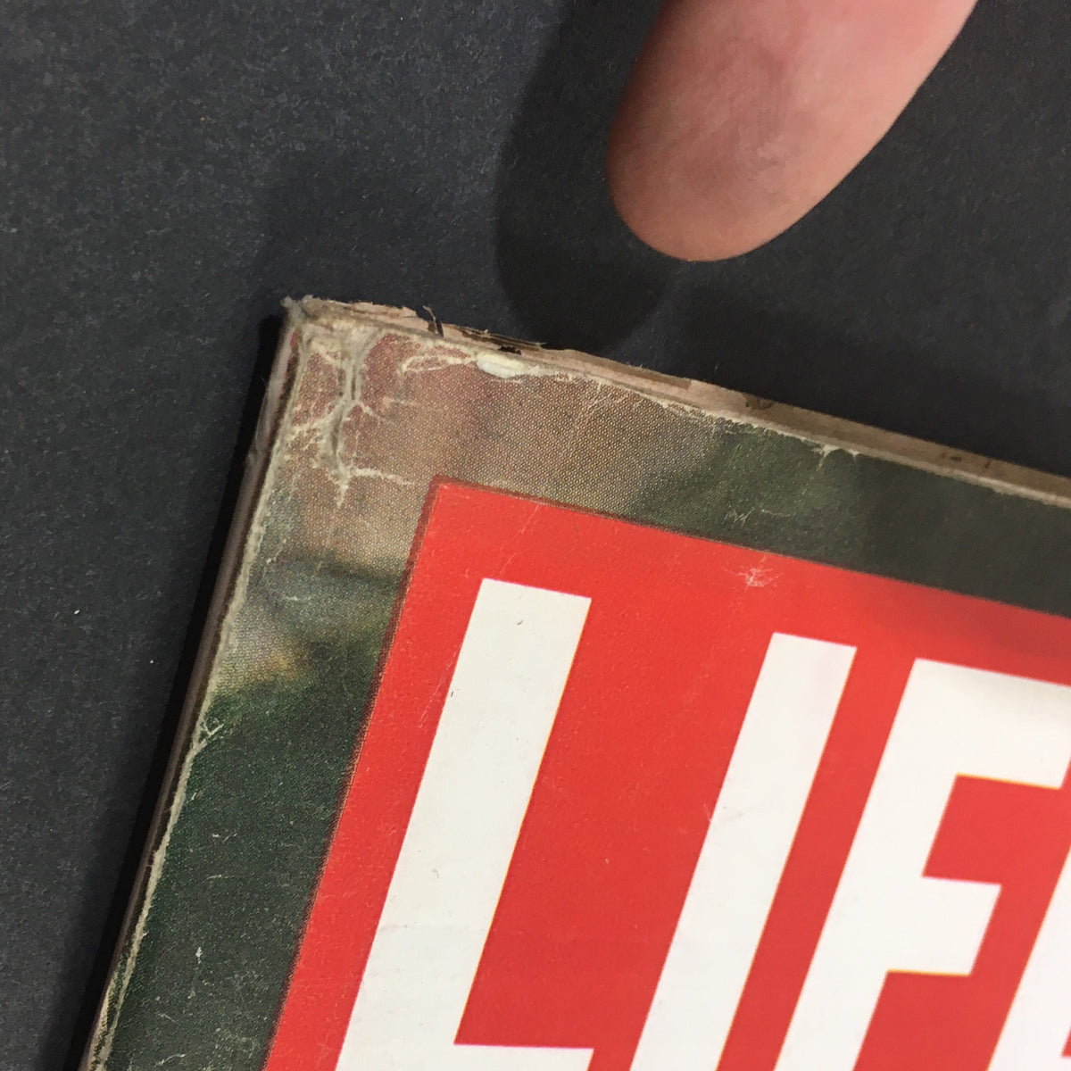 Close-up view of the vintage Life Magazine from May 22, 1964, featuring Barbra Streisand on the cover, showing signs of wear such as minor creasing and exposure of the cover edges, which add character to this collectible item.