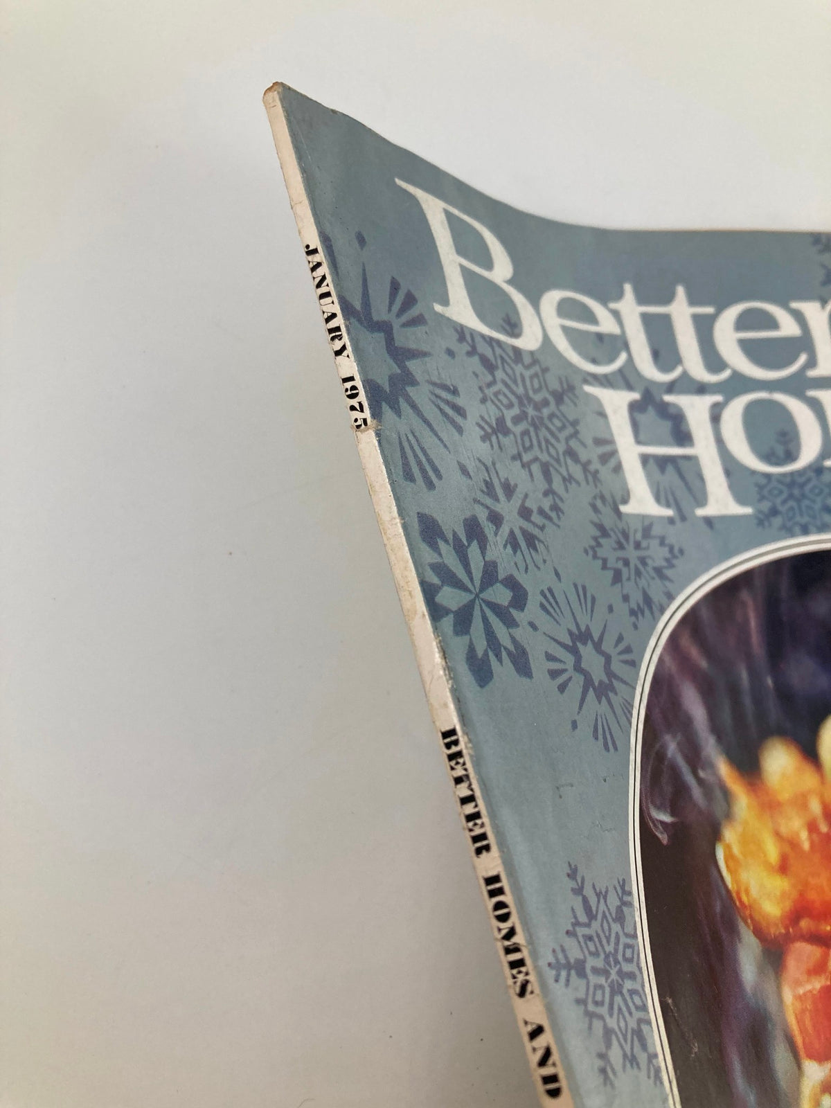Close-up view of the spine of VTG Better Homes and Gardens Magazine January 1975, showcasing the title and publication month.