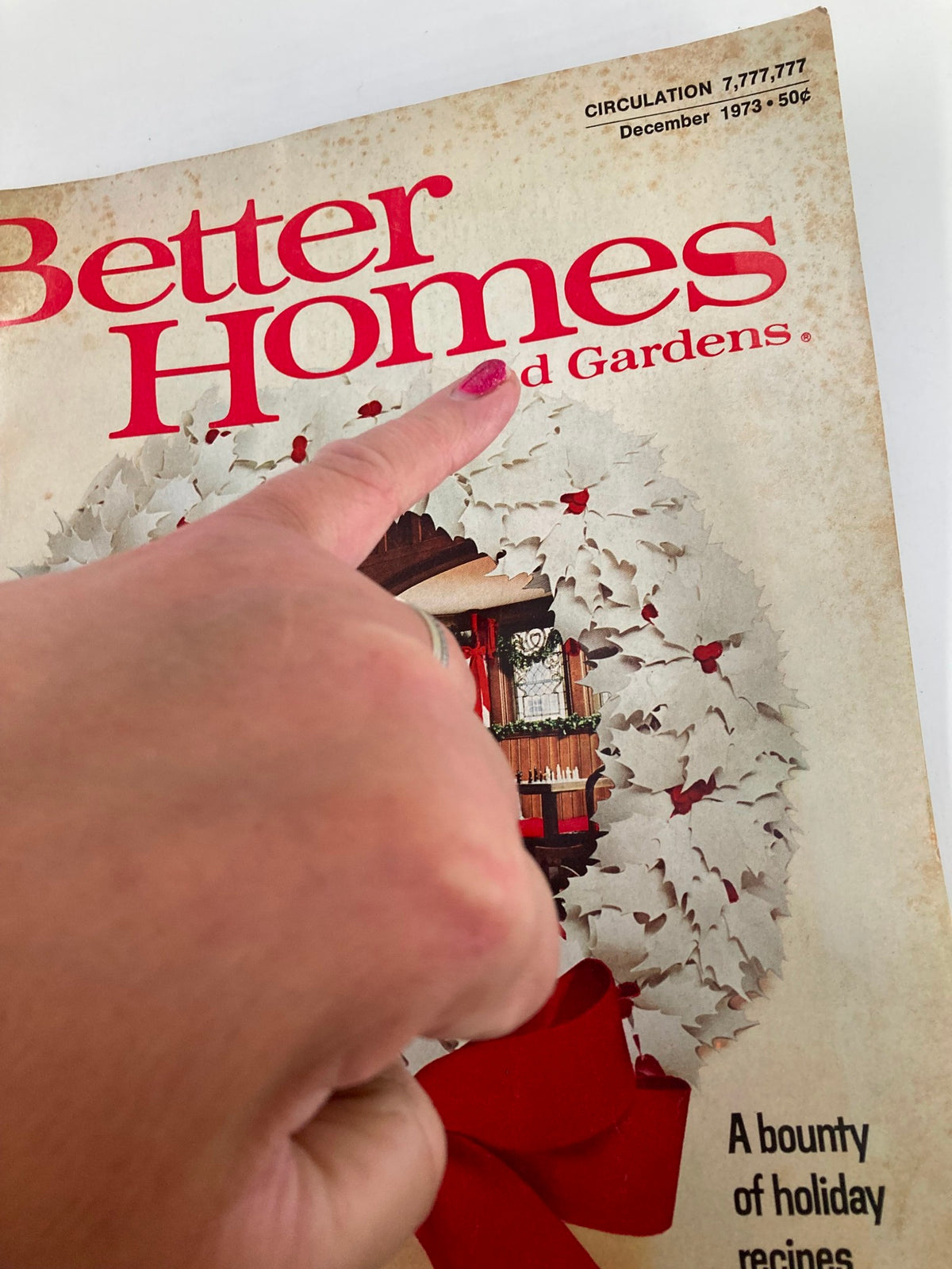 Detail view of the cover of VTG Better Homes and Gardens Magazine December 1973, highlighting the magazine's title and holiday theme with an emphasis on the festive wreath.