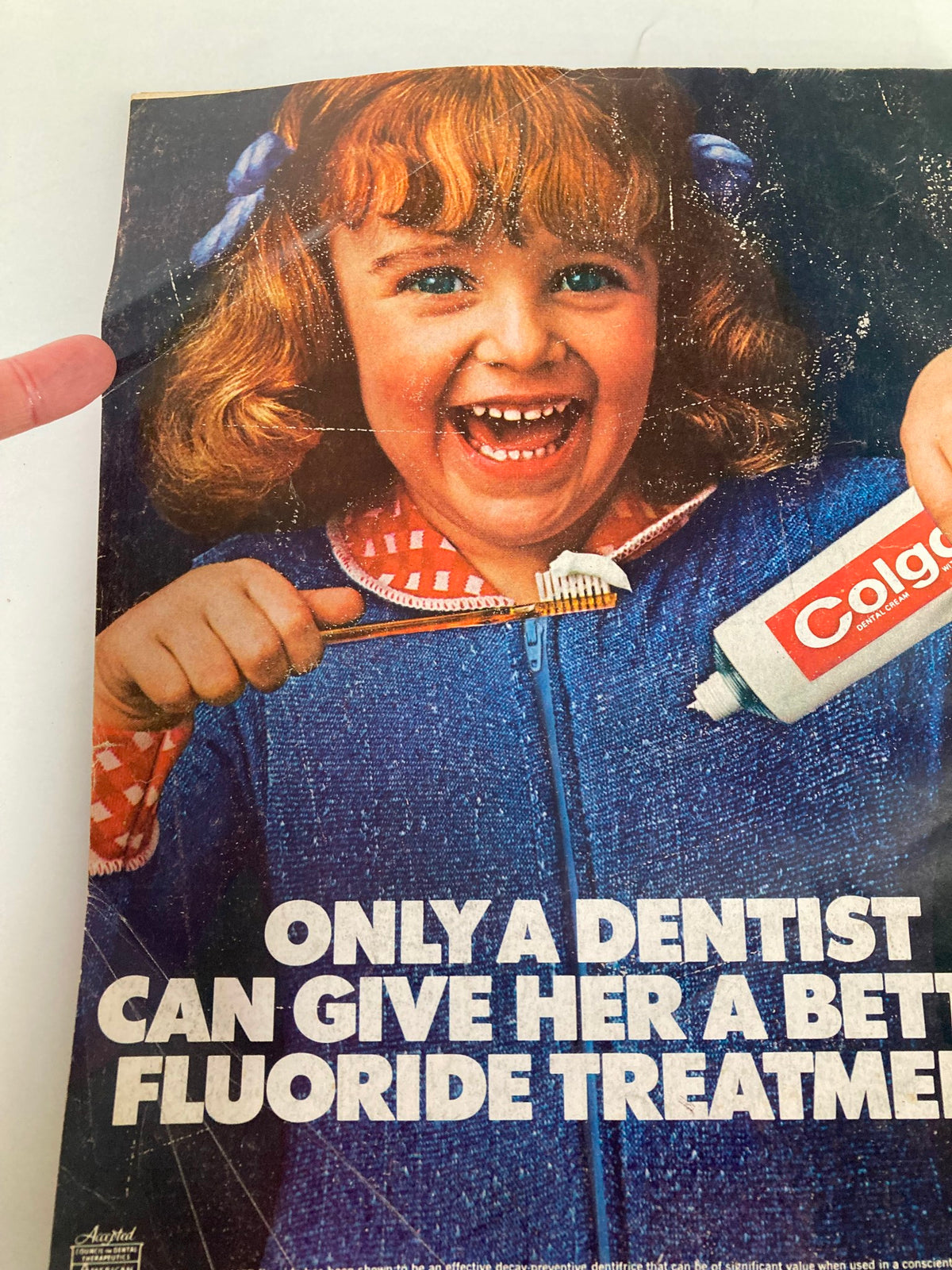 VTG Better Homes and Gardens Magazine December 1973 featuring a vintage advertisement with a young girl smiling while holding a toothbrush and Colgate toothpaste, emphasizing dental health and fluoride treatment.