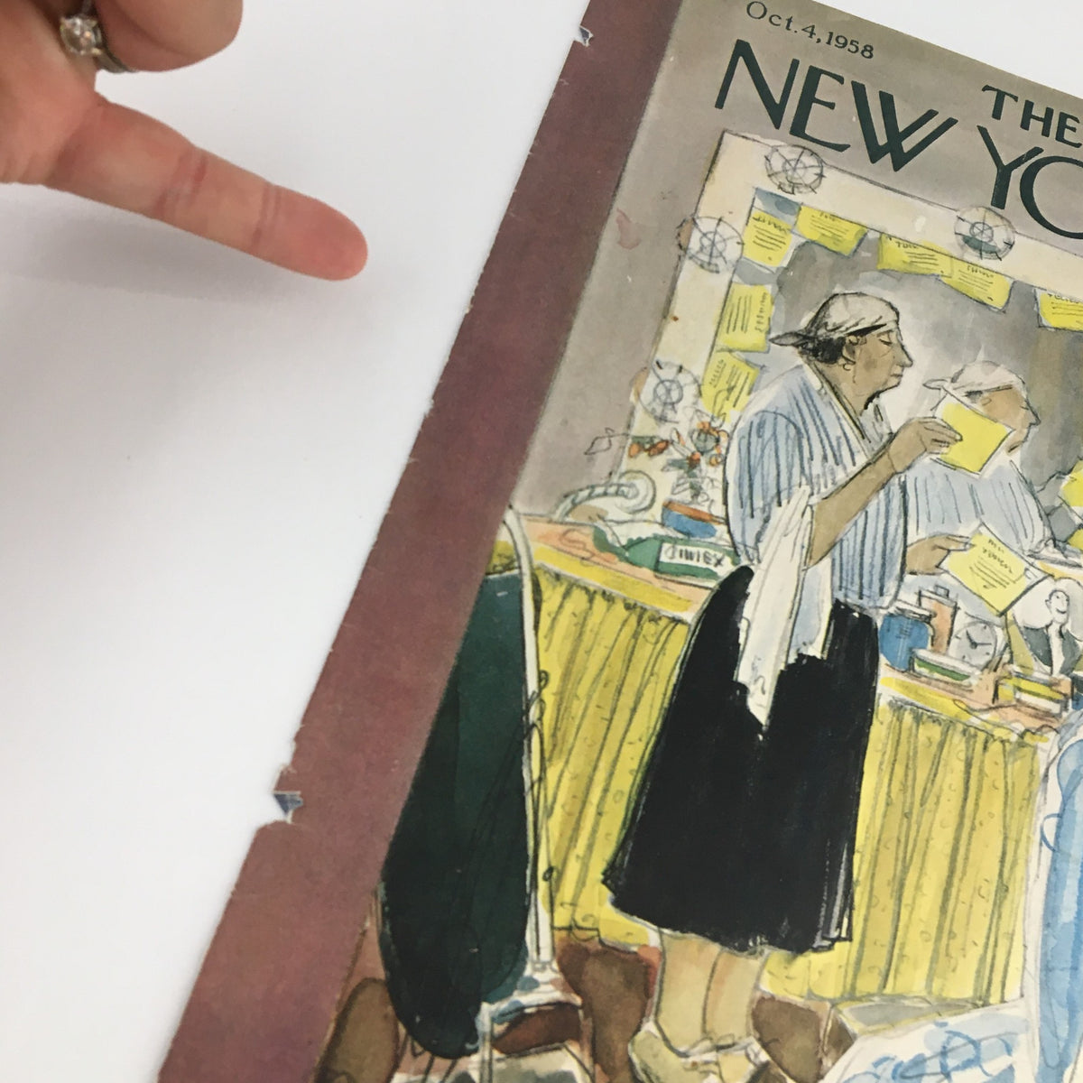 Close-up view of The New Yorker cover, October 4, 1958, depicting a woman at a cluttered worktable with sketches, emphasizing vintage charm, illustrated by Perry Barlow.