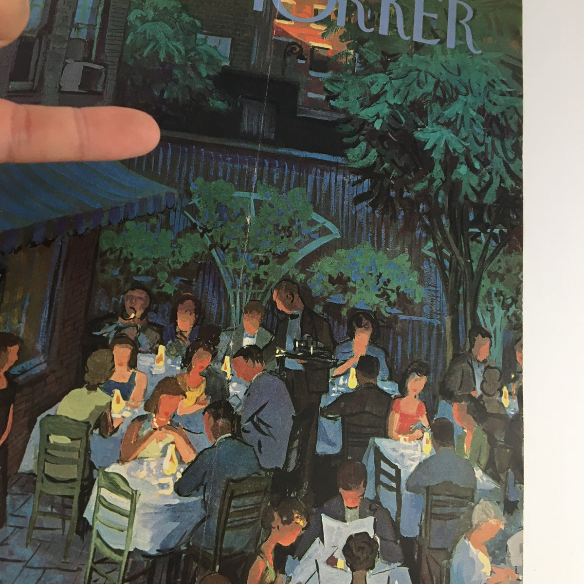 Close-up of The New Yorker cover from August 2, 1958, showcasing a bustling outdoor dining area with tables lit by candles, artfully designed by Arthur Getz.