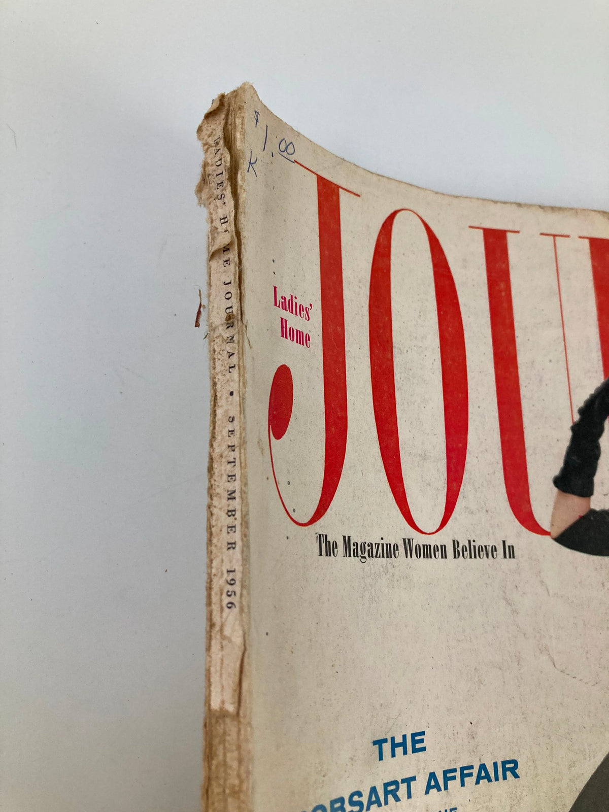 Close-up view of the spine of the Ladies' Home Journal Magazine, September 1956 edition, showing visible wear with the date and title printed on the side.