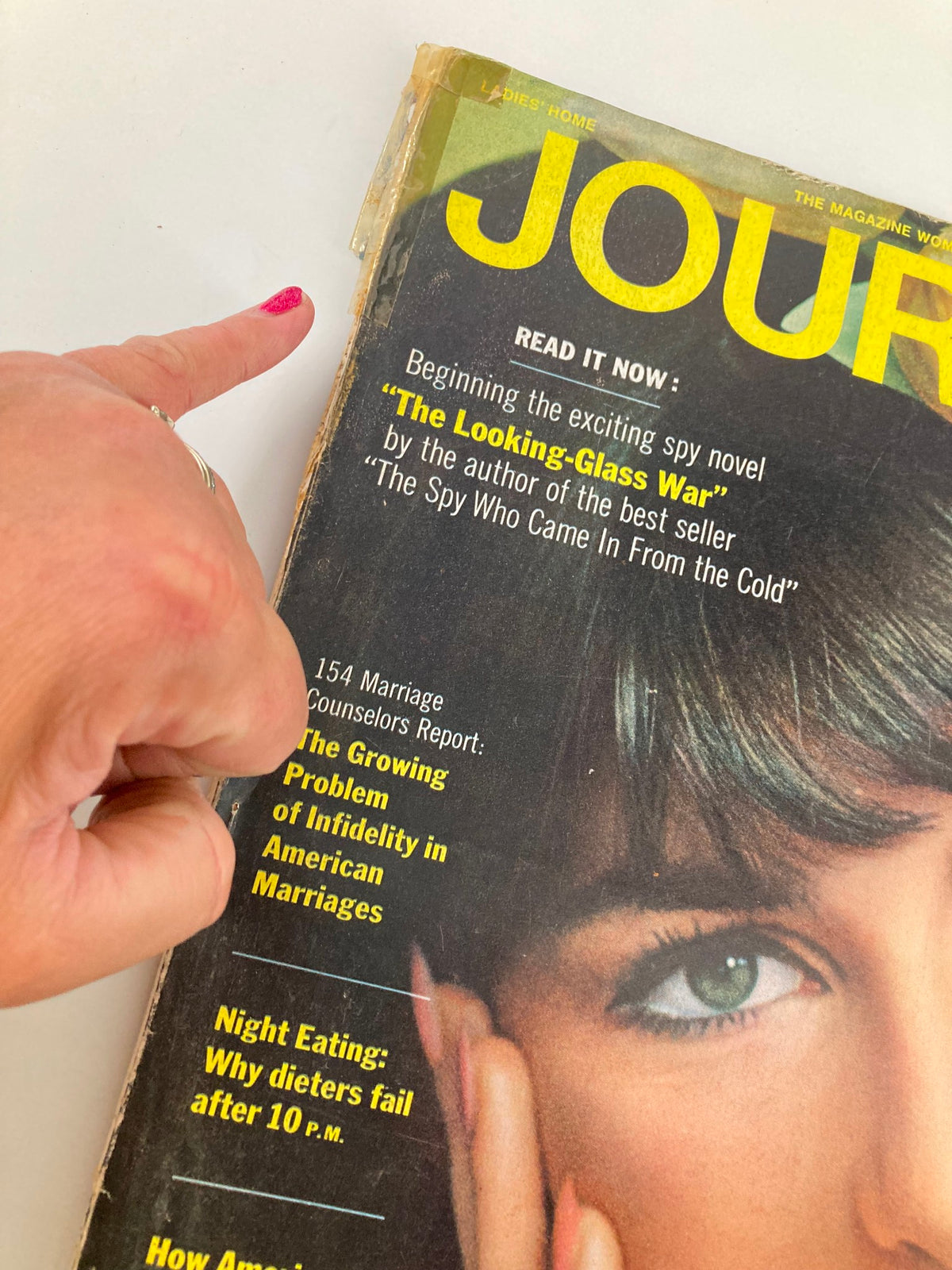 Close-up of the cover of VTG Ladies' Home Journal Magazine April 1965, highlighting the article 'Night Eating: Why Dieters Fail After 10 p.m.' with a finger pointing at the text.