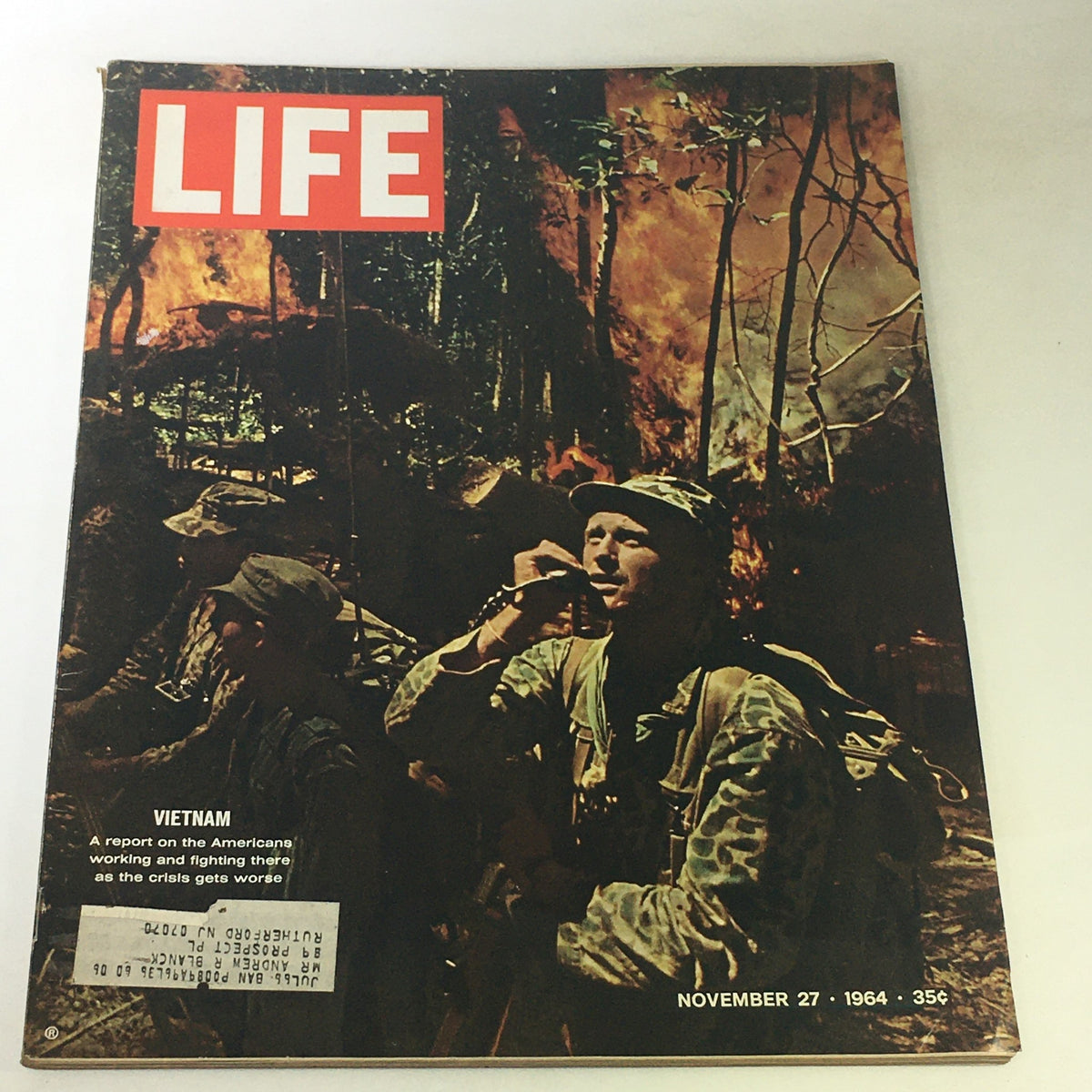 Cover of the Life Magazine, November 27, 1964, titled 'The Crisis Gets Worse in Vietnam'. The image features American soldiers amidst a backdrop of smoke and fire during the Vietnam War, highlighting the intensity of the conflict. This vintage magazine serves as a historical document of the era.