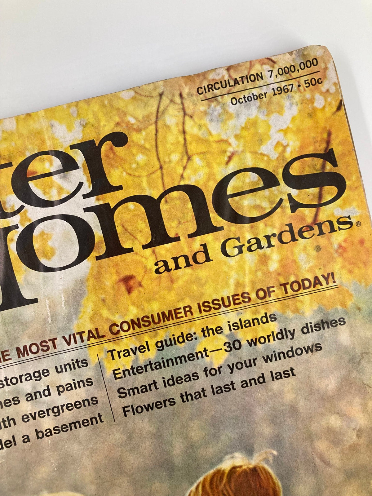 Close-up view of the VTG Better Homes and Gardens Magazine October 1967 cover displaying text about special features including landscaping with evergreens.