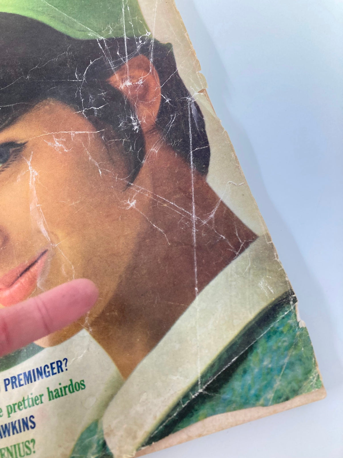 Side view of the vintage McCall's Magazine March 1965 cover showing visible creases and wear, with a focus on the model Tilly Tizzani and her hairstyle, captured by O. Storch.