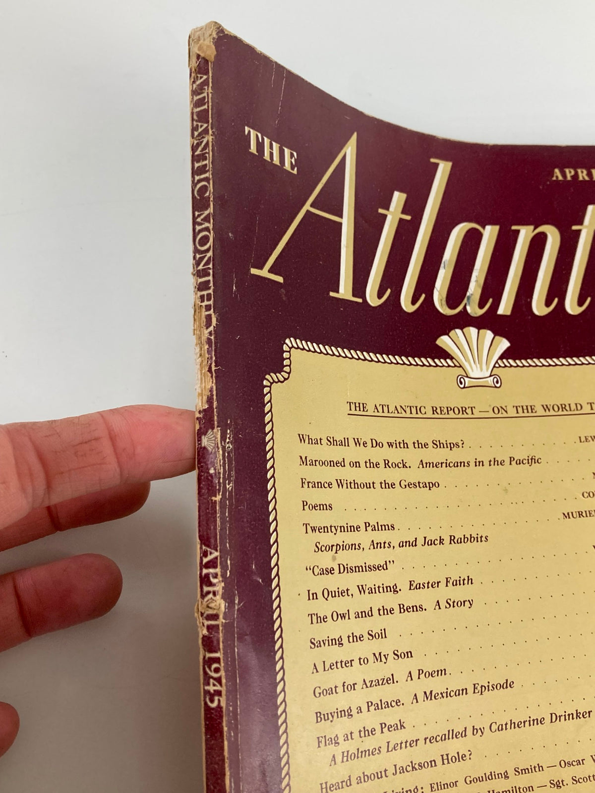 Side view of VTG The Atlantic Magazine April 1945 showing the spine and details of the publication including wear consistent with its vintage nature.