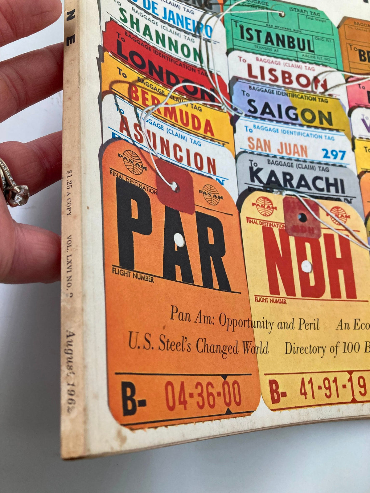 Side view of VTG Fortune Magazine August 1962 showing the title and article 'Pan Am: Opportunity and Peril' along with vintage luggage tags.