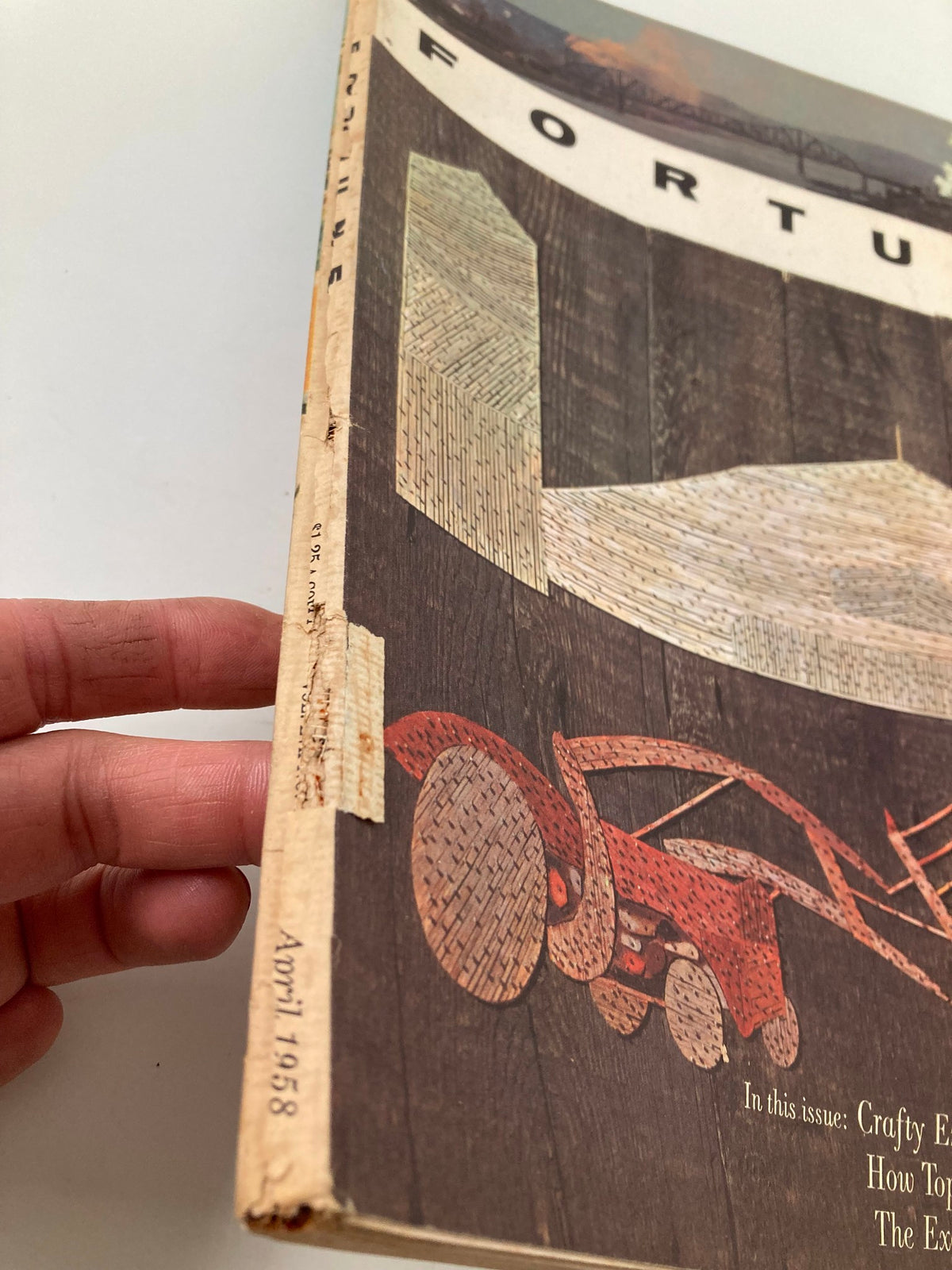 Side view of VTG Fortune Magazine April 1958, displaying the edge and the date 'April 1958'. Highlights the vintage condition with some wear.