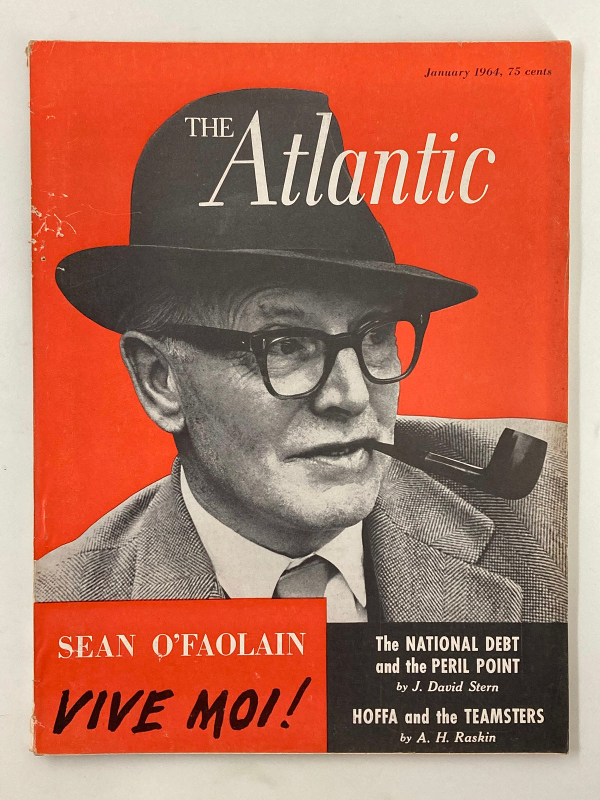 Cover of VTG The Atlantic Magazine January 1964 featuring Sean O'Faolain with the title 'Vive Moi!'. The magazine showcases a striking orange background, highlighting articles from the era, including discussions on national debt and labor unions.