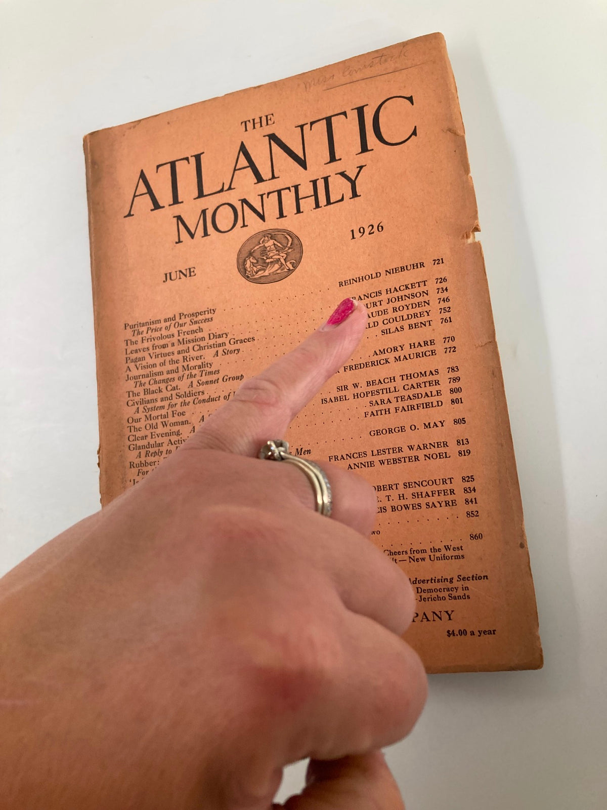Close-up of Vintage The Atlantic Magazine June 1926 cover showing a hand pointing at the title and contents.