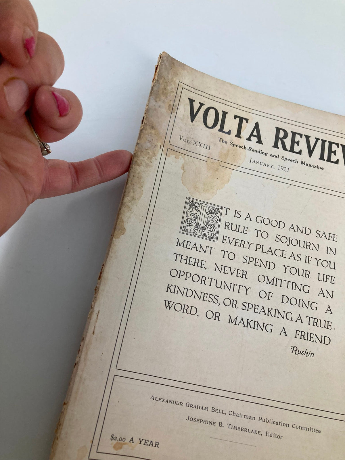 Close-up of VTG Volta Review Magazine January 1921, highlighting the cover details and condition with a hand pointing to the edge.