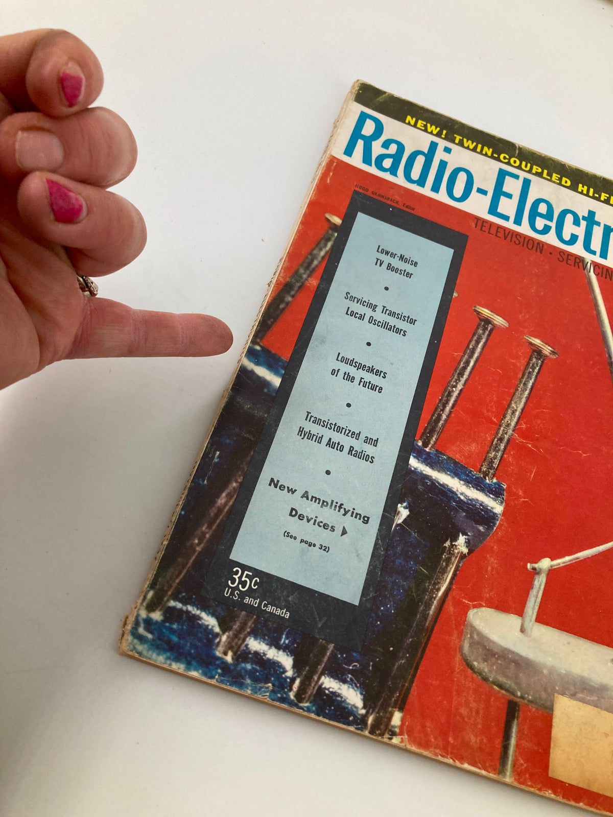 Hand holding the VTG Radio-Electronics Magazine November 1957 showcasing Spacistor, highlighting key articles on the magazine cover.