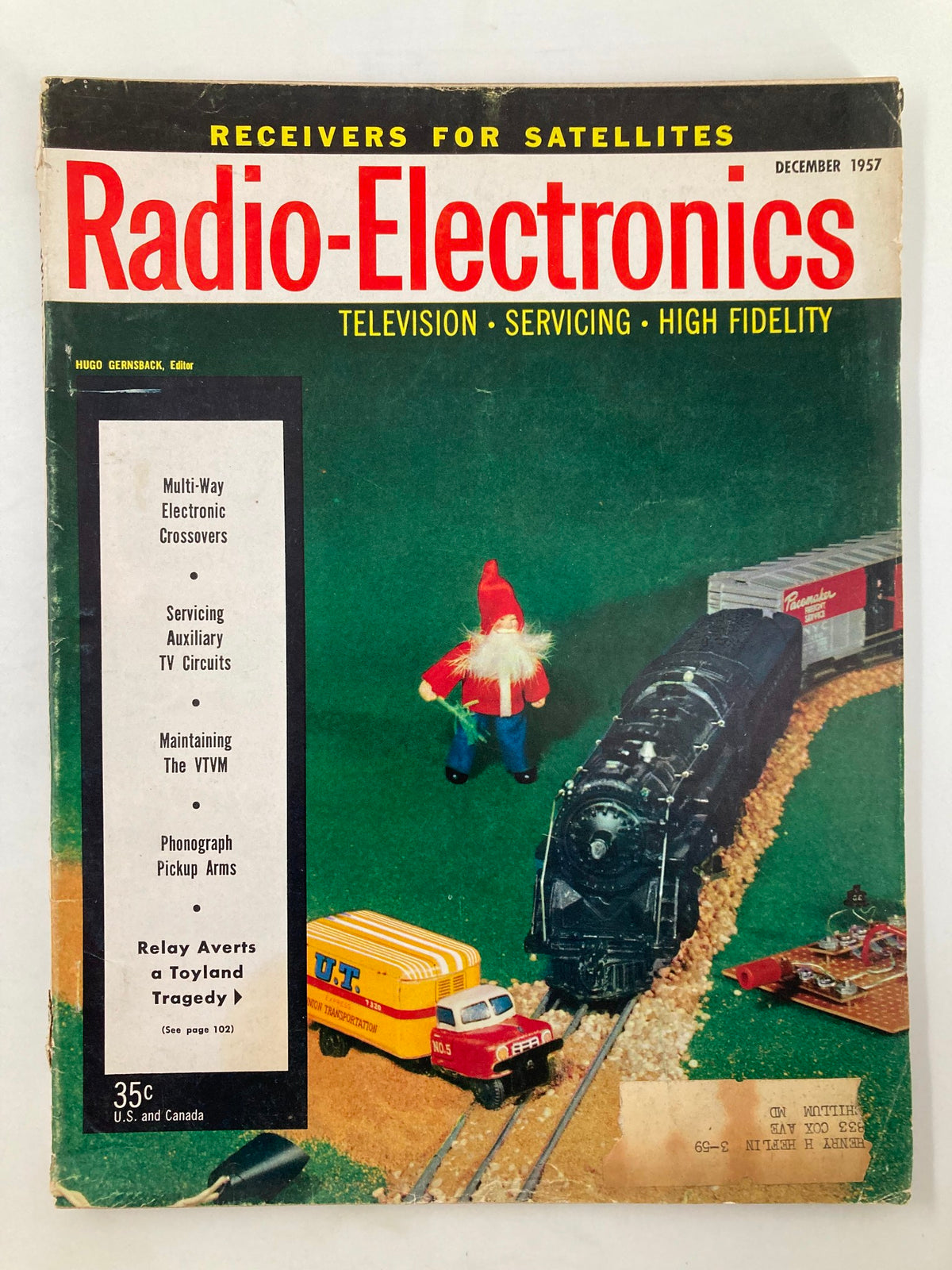 VTG Radio-Electronics Magazine December 1957 cover featuring a toy train and figurine, with the title "Relay Averts a Toyland Tragedy" prominently displayed.
